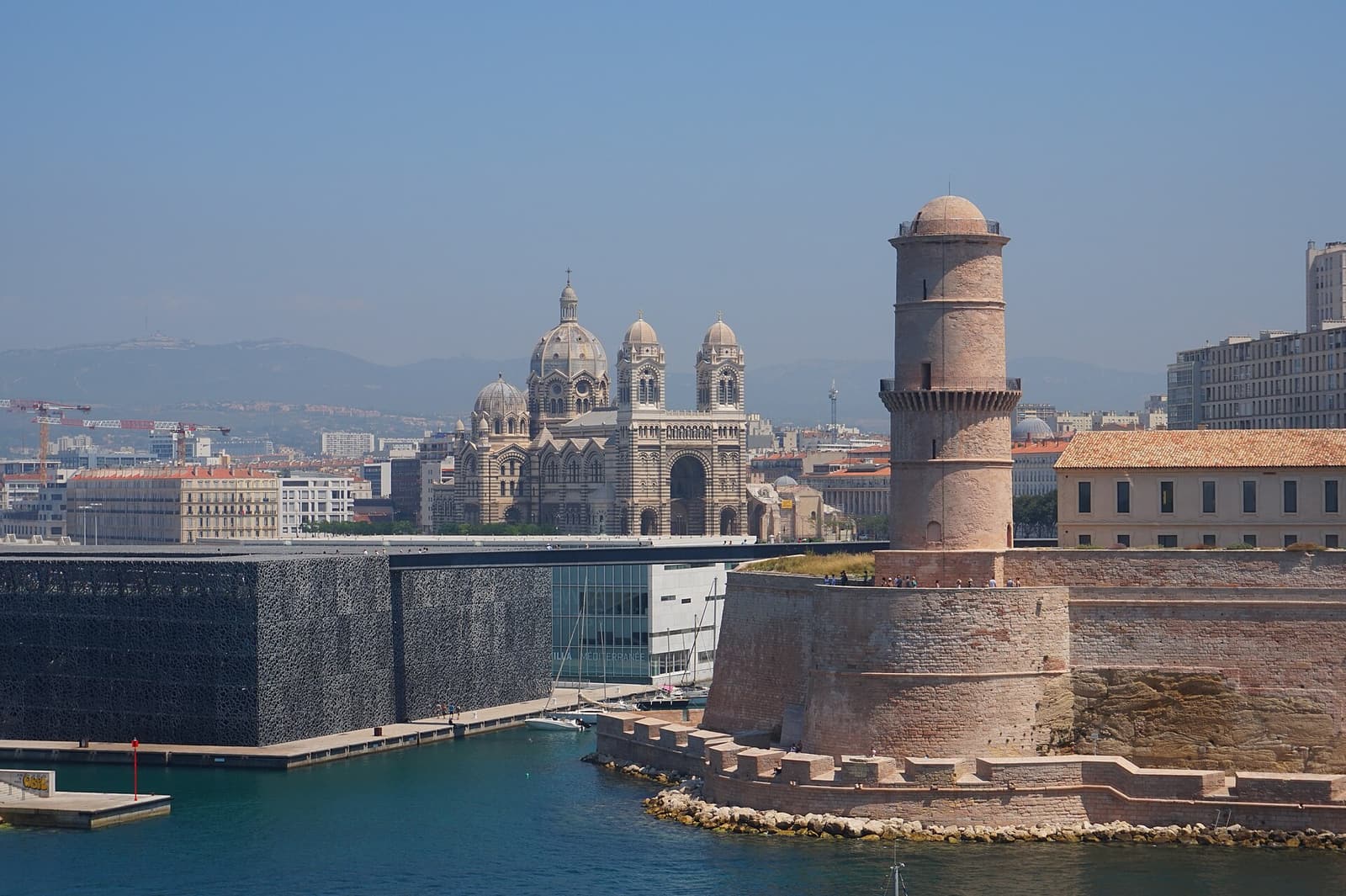 The MuCEM cube and the tower of Fort Saint-Jean at the harbour entrance, with the cathedral of La Major behind