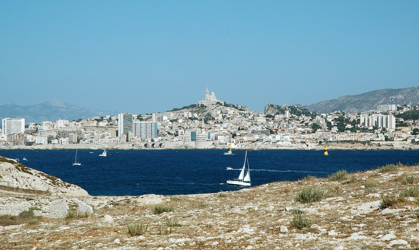 Marseille and Notre-Dame de la Garde seen across the bay from the Frioul island of Ratonneau